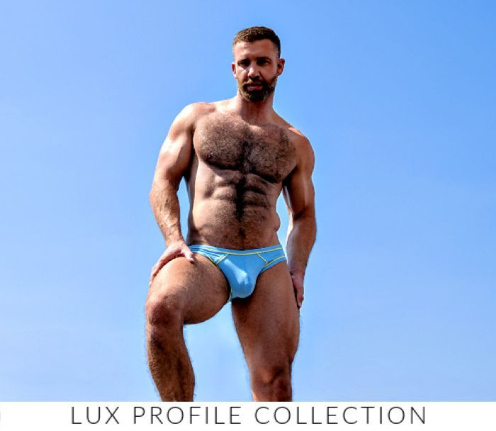 Shop the Jack Adams LUX Profil Collection. Image: Model wearing a pair of Jack Adams LUX Profile Briefs (w/ piping) in  pacific blue.