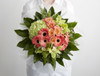 Zesty, fruity lime green orchids are paired with fresh jade green hydrangeas, mixed with coral roses and germini. This bouquet is perfect to brighten up someones day. 