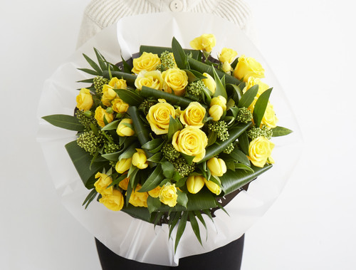 The promise of Spring, we put together this mix of Moonwalk roses, yellow spray rose, yellow tulip, green skimmia, aspirdista and chico.