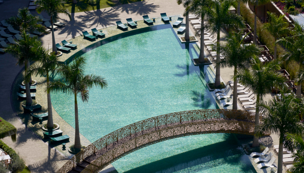 Cruise travelers soaking up the sun on lounge chairs at Savoy Palace while enjoying a boutique resort day pass for an unforgettable Madeira port experience.
