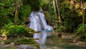 Explore Island Gully Falls (Blue Hole), a hidden oasis with aqua-blue waters, waterfalls, and lush jungle. 