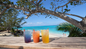 Cruise passengers enjoying the Sip & Sea private beach club with Resort for a Day, including unlimited drinks, snorkeling, paddleboarding, relaxing on beach loungers, and scenic boat ride from Nassau