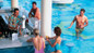 Resort day pass guests drinking cocktails at the swim-up bar at the RIU Palace Resort in Cabo San Lucas. 