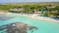 Families having fun with non-motorized water sports like kayaking, snorkeling, and sailing during a Viva Wyndham Dominicus Beach day pass experience.