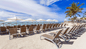 Beach with lots of lounge chairs at Sonesta Maho Beach Resort in St. Maarten.  Reserve lounge chairs and towels by the beach or pool for a comfortable day in the sun.