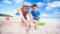 Family of day pass guests building sand castles at Bay Gardens Beach Resort in St. Lucia. 