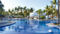 Relaxing pool & loungers at Hotel RIU Jalisco in Puerto Vallarta.  Travelers staying active with non-motorized water sports, gym access, and poolside activities during their RIU Jalisco day pass in Puerto Vallarta.
