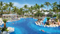 Resort day pass guests enjoying the fun pool area at Hotel RIU Jalisco in Puerto Vallarta. Families relaxing by one of the two swim-up bars while children enjoy the kids’ pool and waterslide during a Puerto Vallarta resort day pass. 