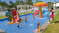 Kids splash pad at Hotel RIU Jalisco in Puerto Vallarta.  Couples relaxing at one of the pools with swim-up bars while enjoying unlimited drinks and day pass amenities at a Puerto Vallarta cruise port resort.