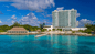 Guests enjoying their Resort for a Day Pass at Westin Cozumel, snorkeling in crystal-clear waters and kayaking along the white sand beach with unlimited all-inclusive food and drinks