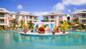 Bay Gardens Beach Resort pool area with lounge chairs in St. Lucia.