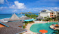 Aerial view of Bay Gardens Resort pool area & nearby coastline. 