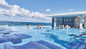 Resort day pass guests enjoying the infinity pool at the adults-only RIU Palace Resort in Nassau.