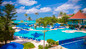 Picturesque pool area with lounge chairs at Breezes Resort in Nassau. 