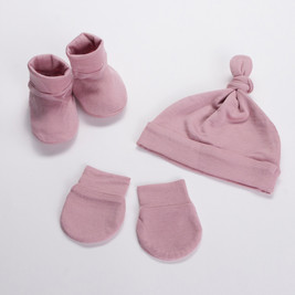 A flat lay image of The Sleep Store's All Seasons Merino/Tencel Booties, Beanie & Mittens Pack in the colour Dusky Pink.