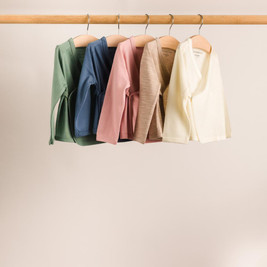 Rack of five colours of Jersey New Zealand Merino Wool Kimono Cardigans hanging on a wooden rail