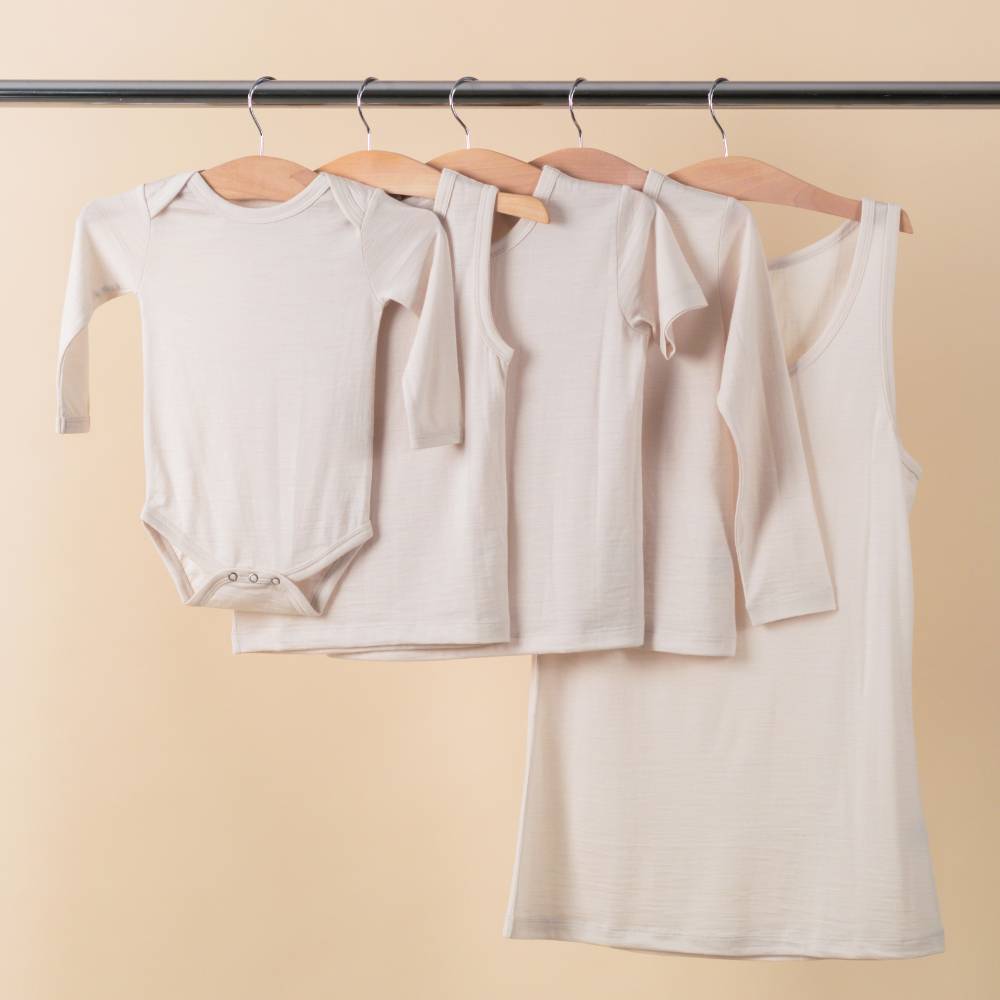 The Sleep Store All Seasons Merino / Tencel range in milk hanging on a rail