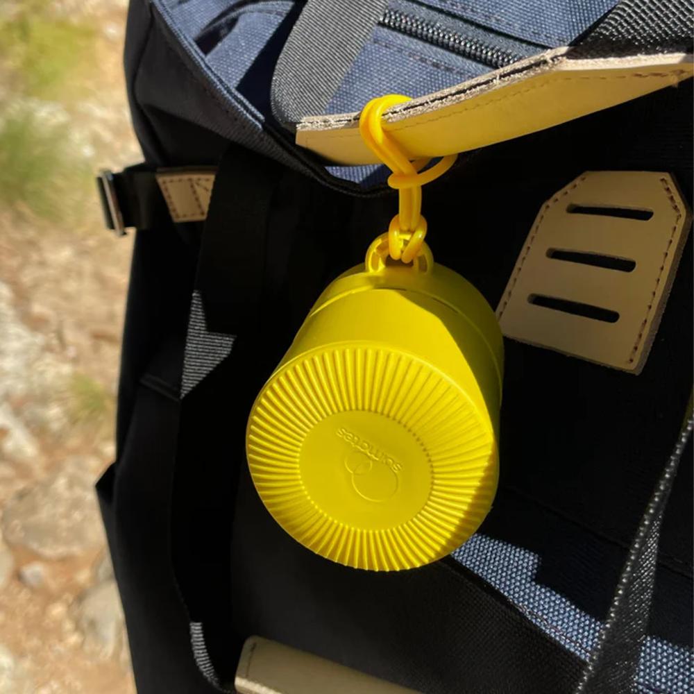 Solmates Refillable Sunscreen Applicator - Sunshine Yellow clipped to a buggy handle