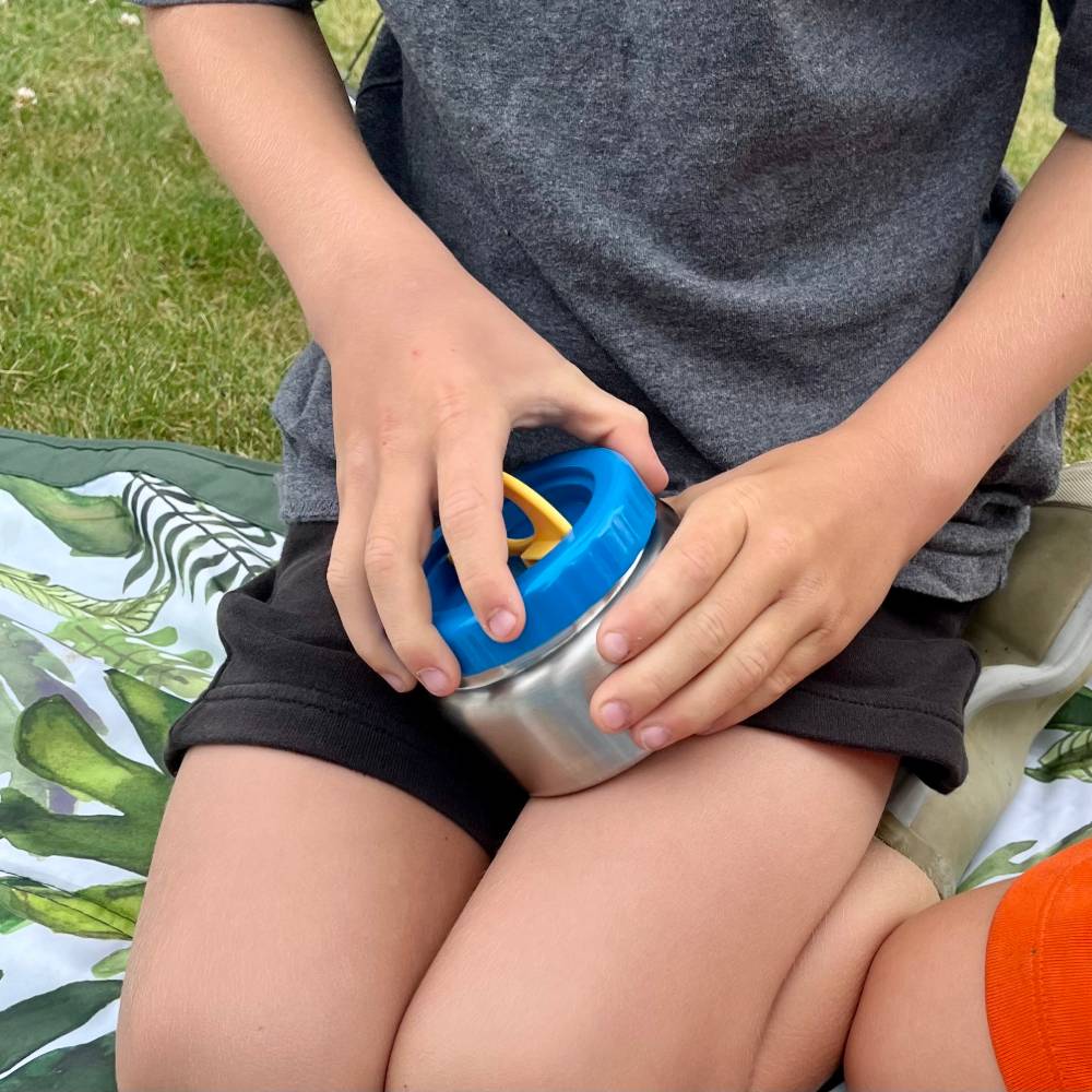 Image of a child opening the Blue Sleep Store Insulated Food Jar.