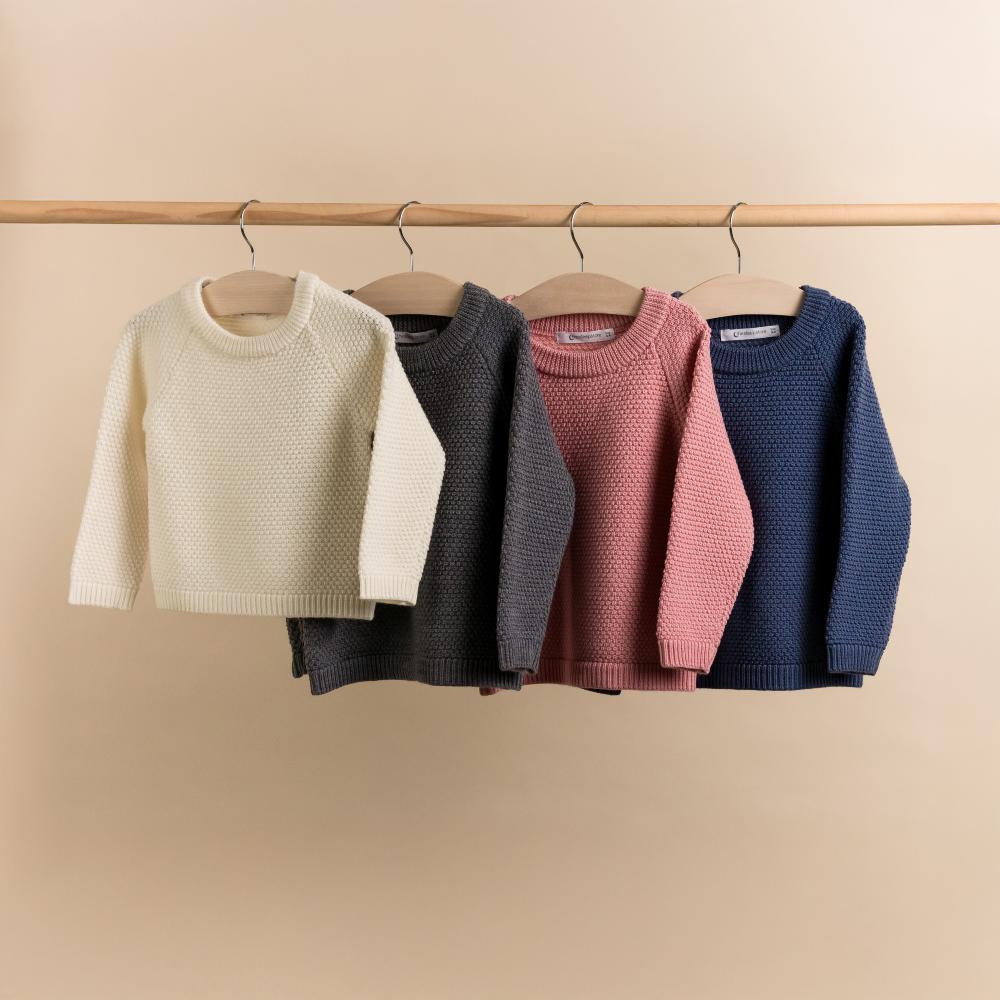 Rack of The Sleep Store Merino Knit Crew Jumpers hanging on a rail