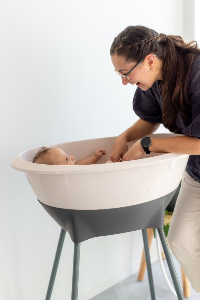 mum bathing baby in luma baby bath