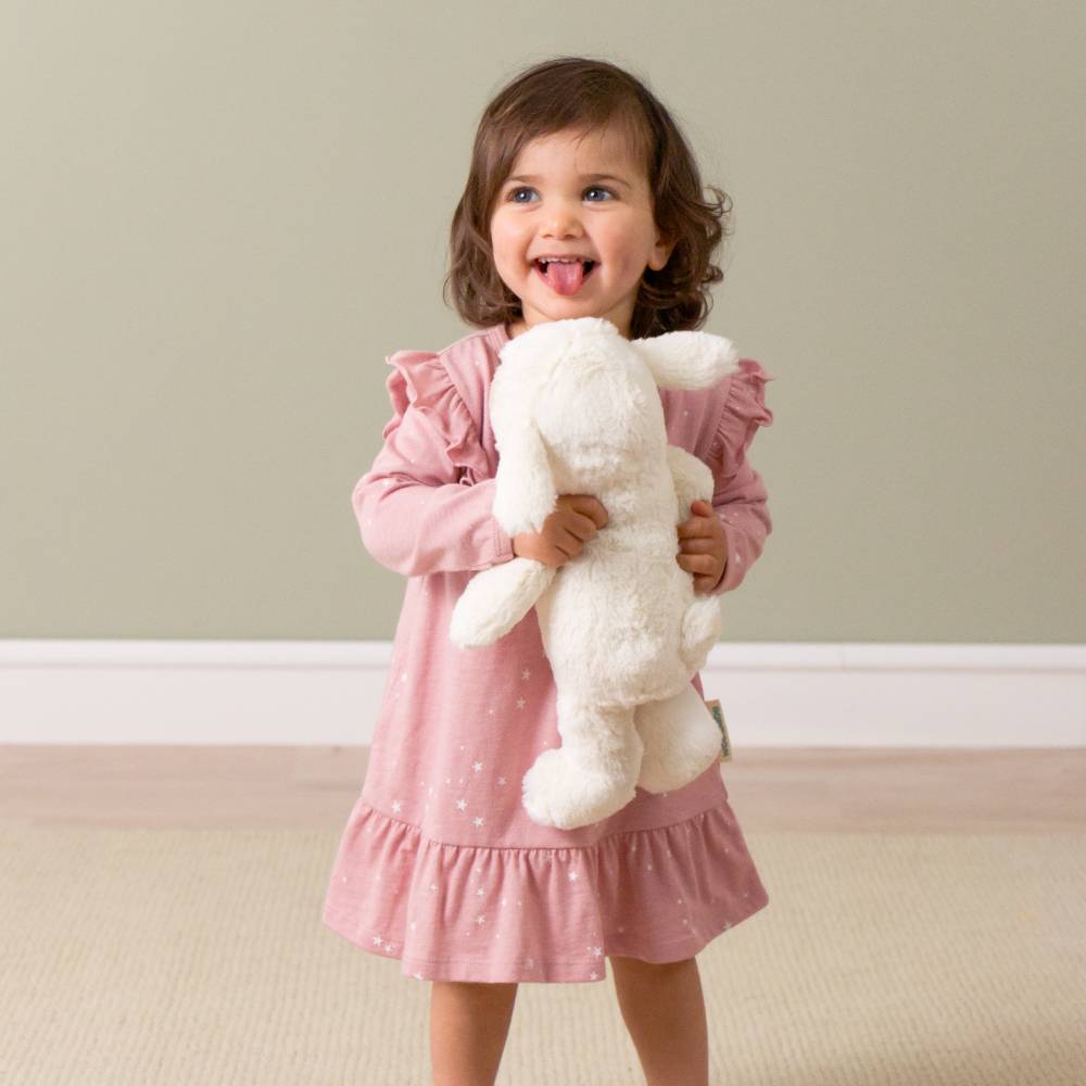 Happy girl holding her loulou lamb glow friend