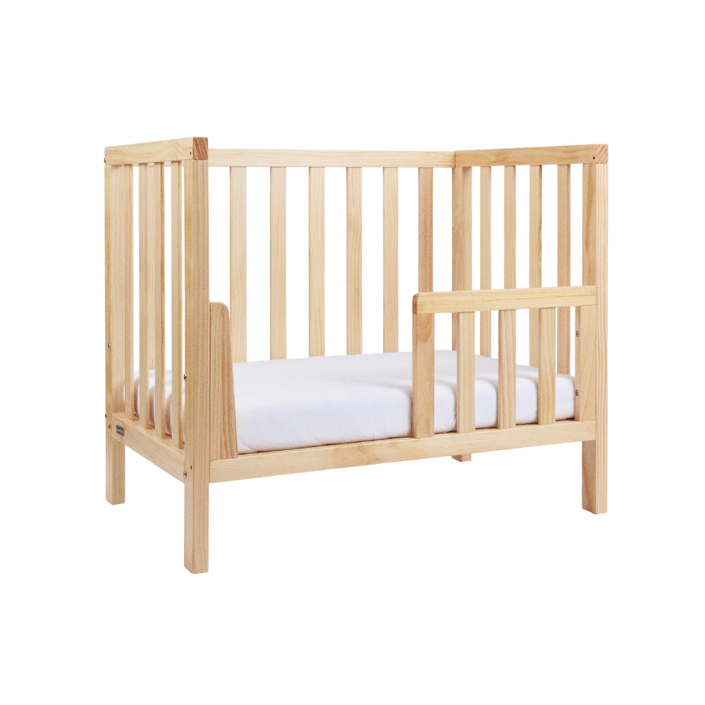 The Frank Mini Cot converted to toddler bed with side rail