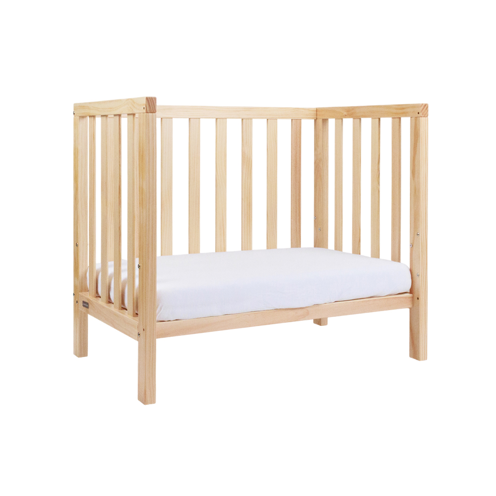The Frank Mini Cot converted to toddler bed with the side off