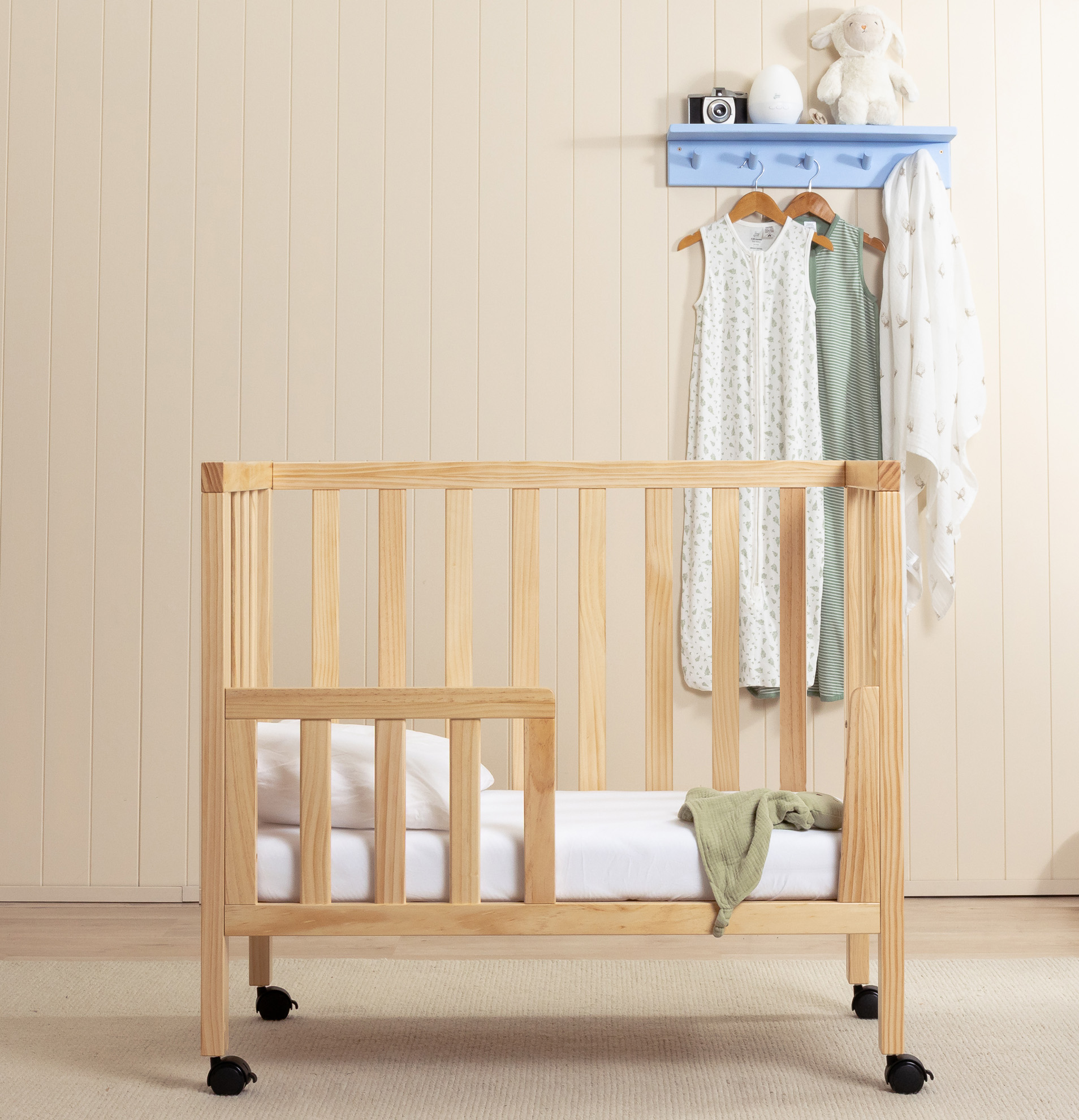 The Frank Mini Cot in a light coloured Nursery converted to toddler bed with side rail