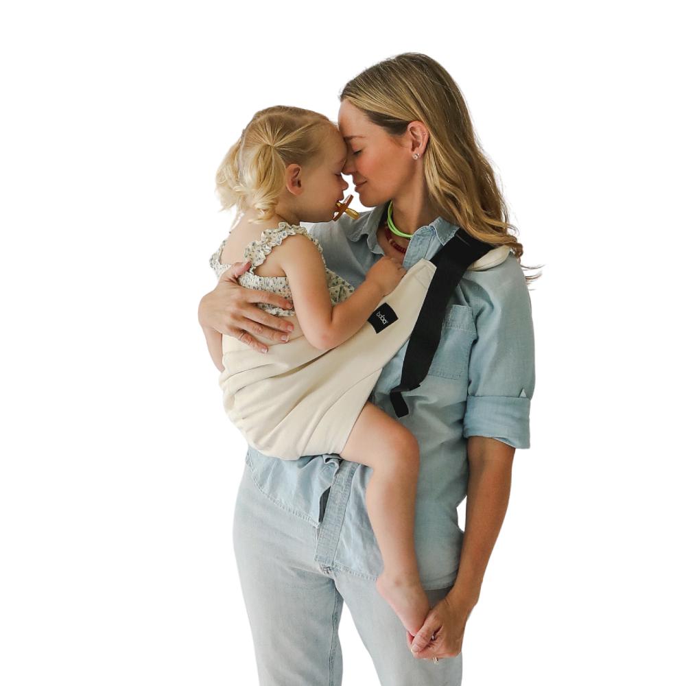 Beco Buddy Toddler Hip Carrier, Woman wearing the oat carrier with a toddler.