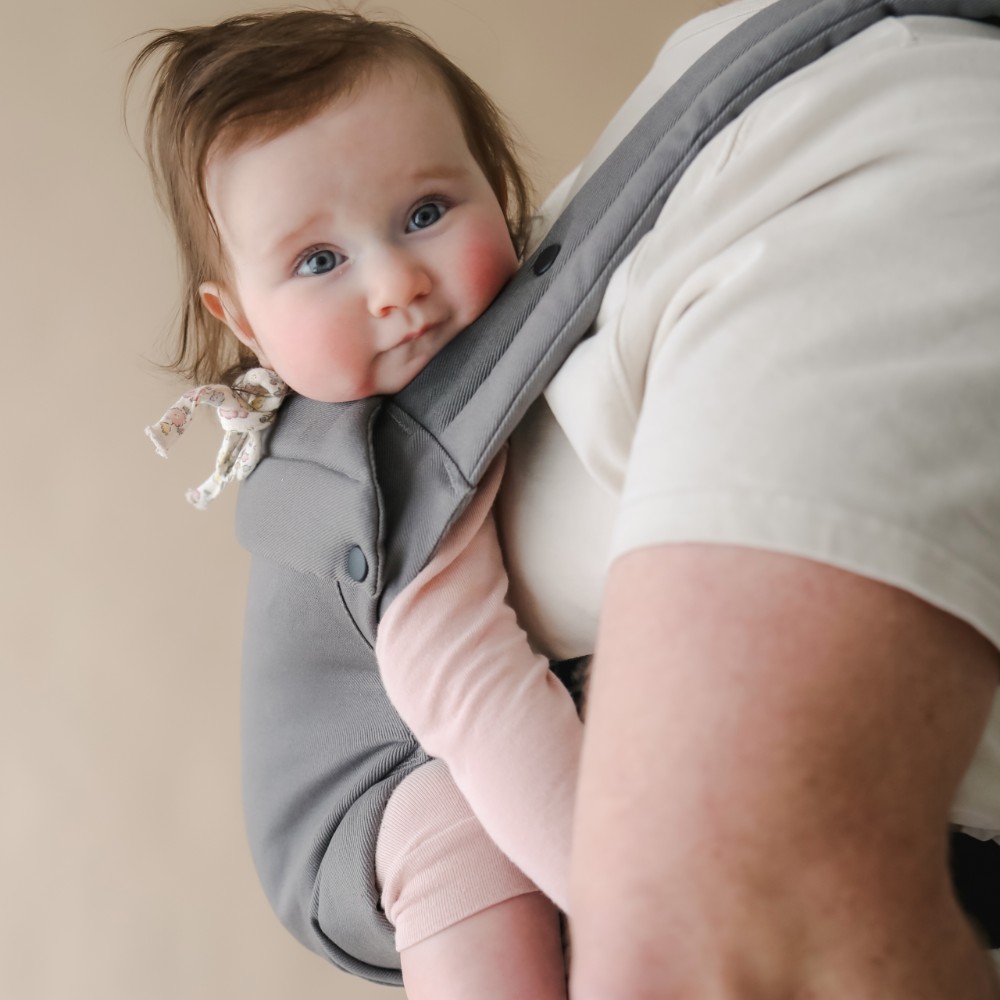 Close up of baby being carried in a grey boba auri baby carrier