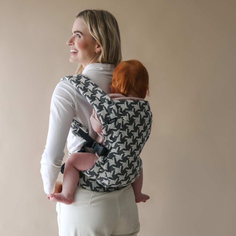 Mum carrying baby on back in a grey houndstooth boba auri baby carrier