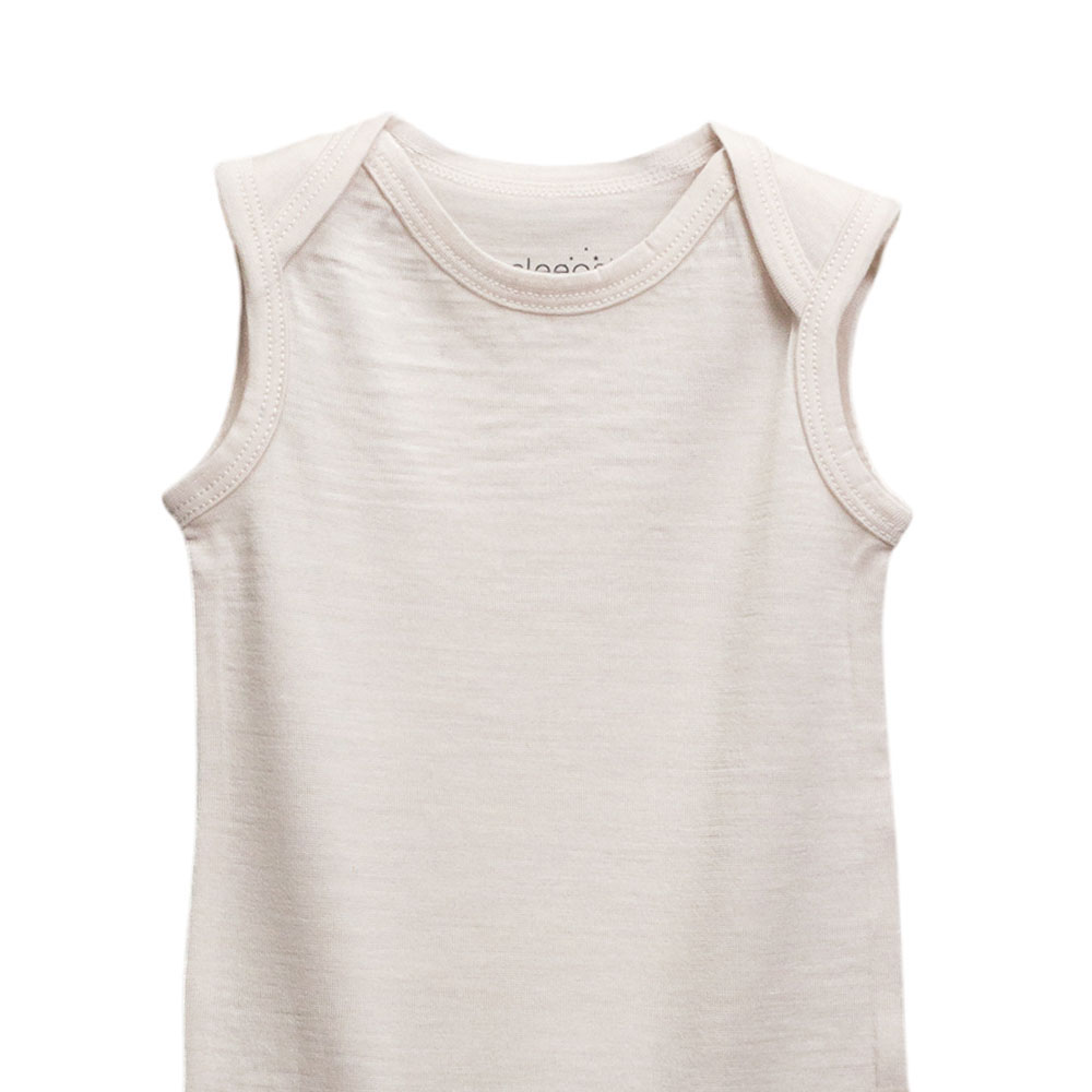 A close up image of the envelope neckline of The Sleep Store's All Seasons Merino/Tencel Singletsuit in the colour Milk.