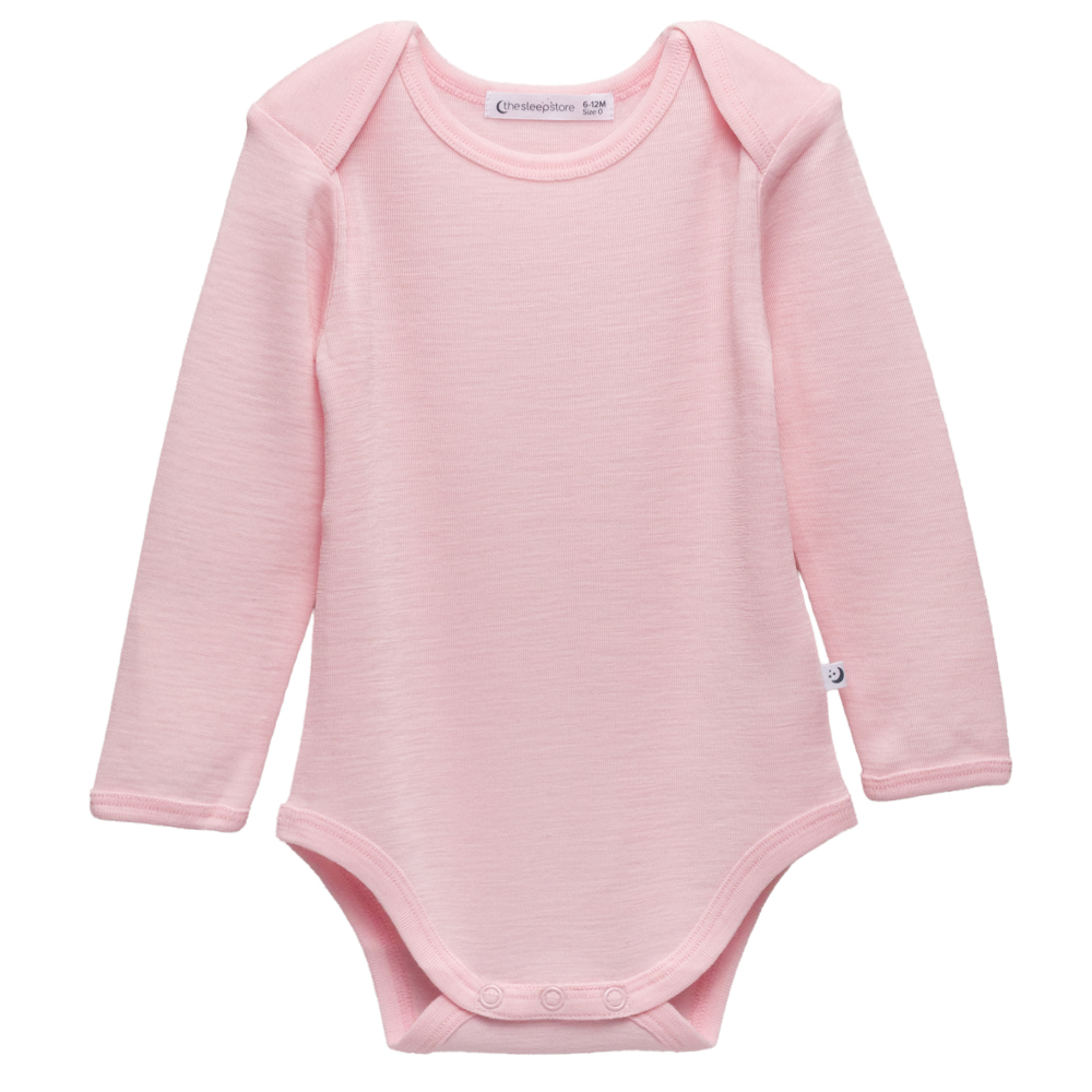 A clearcut of the Sleep Store Deluxe New Zealand Merino Wool Long Sleeve Bodysuit in the colour Blush.