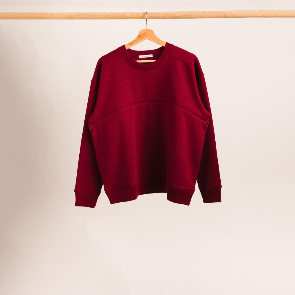 The sleep store Merino fleece crew style breastfeeding jumper in berry hanging on a rack