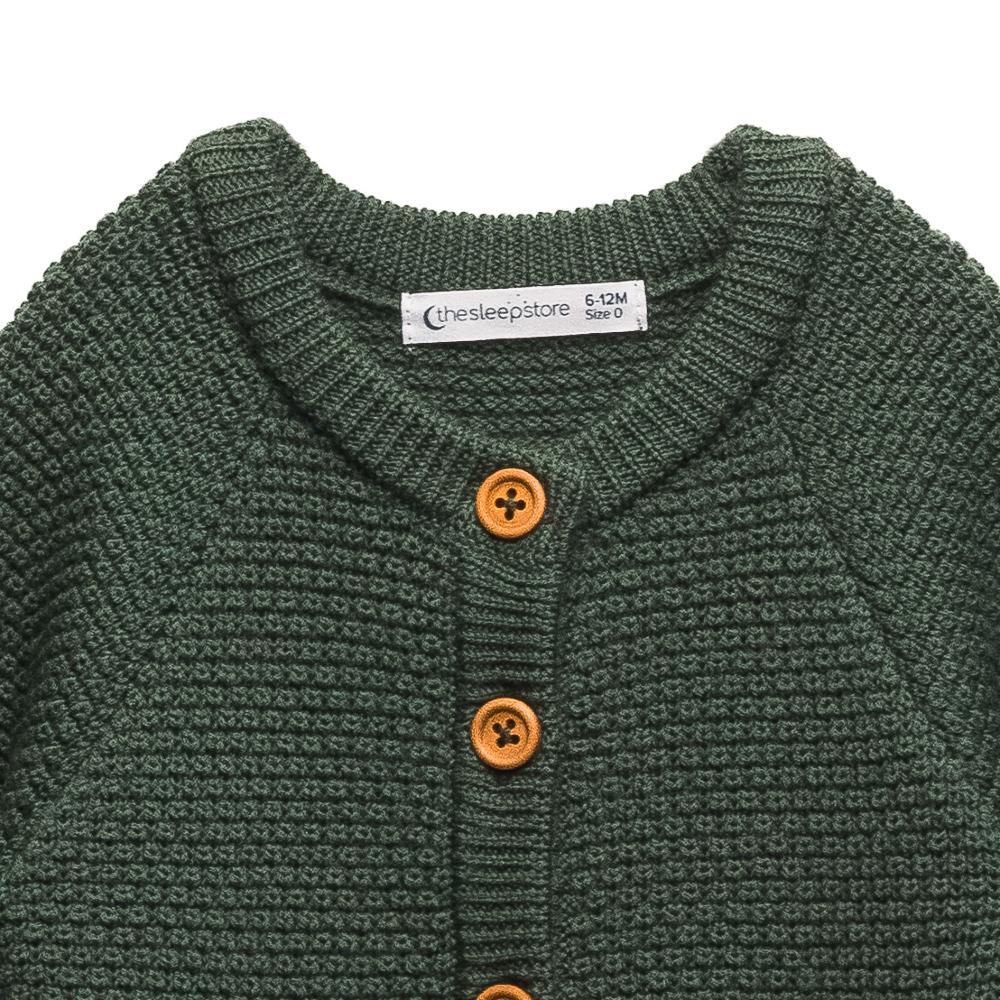 wooden button detailing on The Sleep Store Merino Knit Onesie