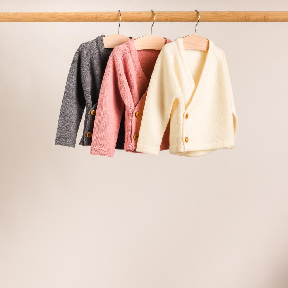 A hanging shot of The Sleep Store Merino Knitwear Kimono Cardigan in Grey Marl, Pink and Cream.