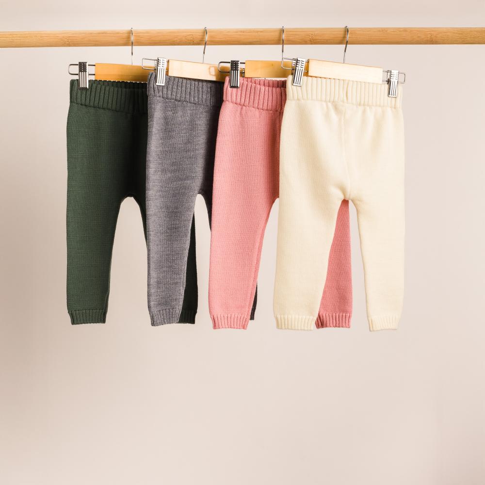A hanging shot of The Sleep Store Merino Knitwear Pants in 4 colours on a wooden rail.