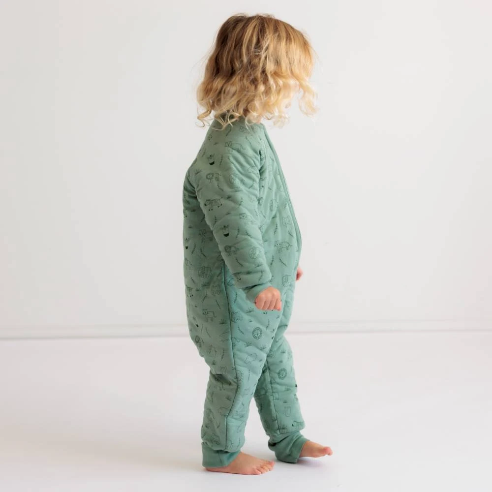 Side view of toddler girl standing wearing The Sleep Store Organic Cotton 3.0 tog Sleeved Sleep Suit
