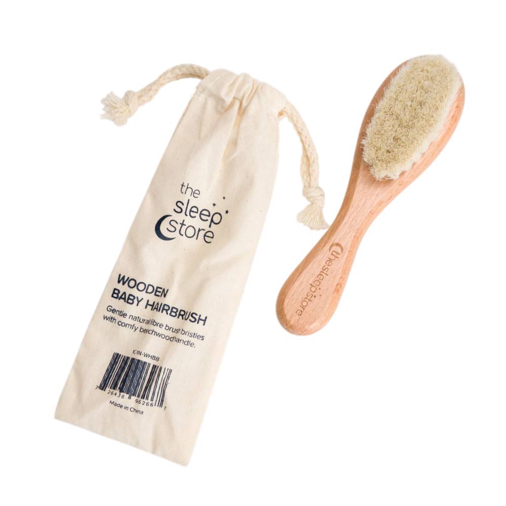 A clearcut image of The Sleep Store Wooden Baby Hairbrush with drawstring storage bag to the left side.