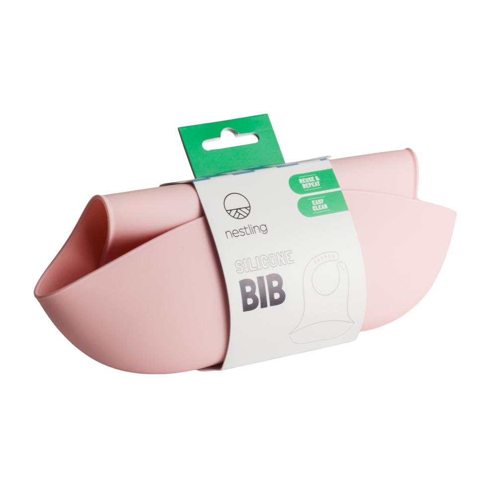 A clearcut image of the Nestling Silicone Bib in the colour Dusty Pink, wrapped in packaging.