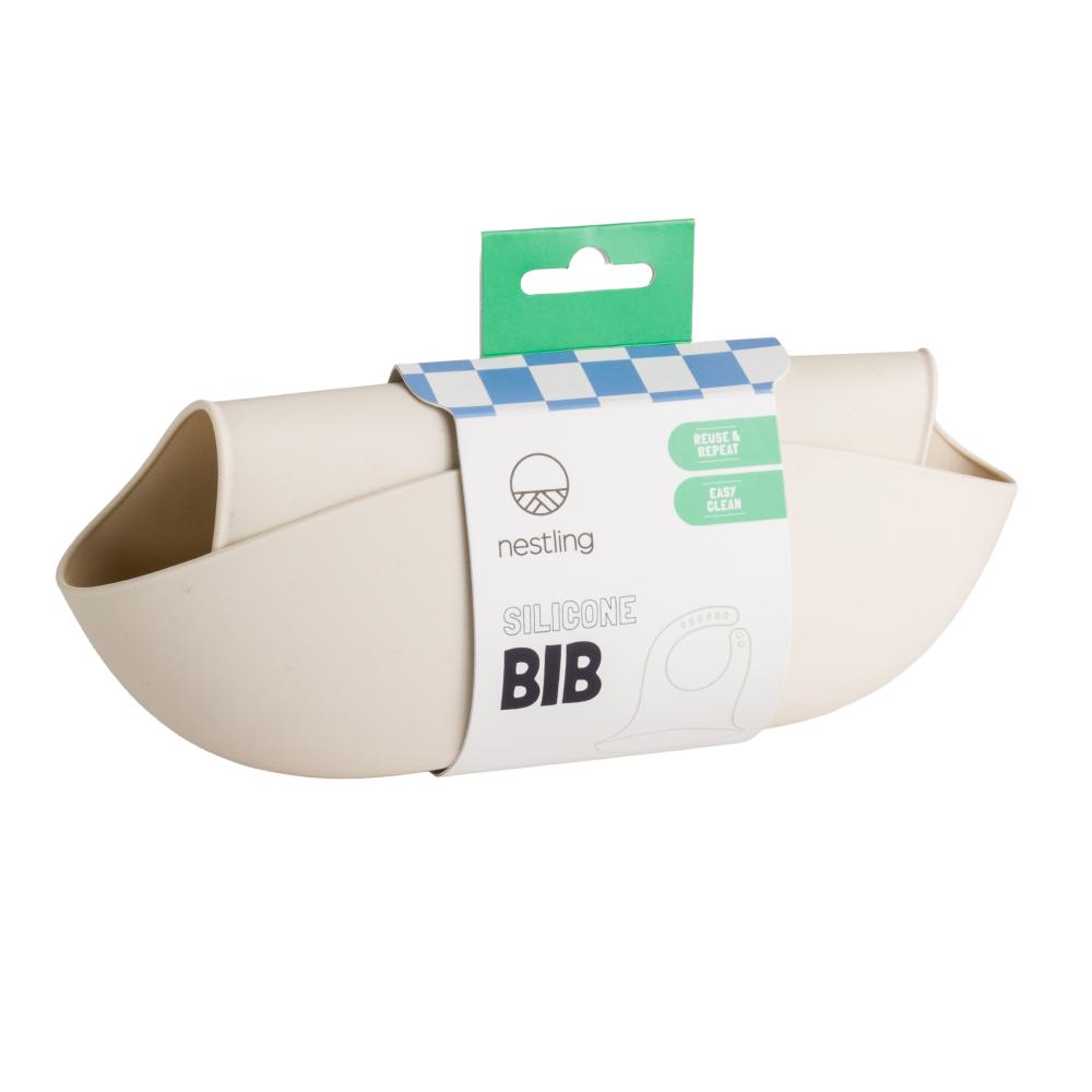 A clearcut image of the Nestling Silicone Bib in the colour Oat, wrapped in packaging.