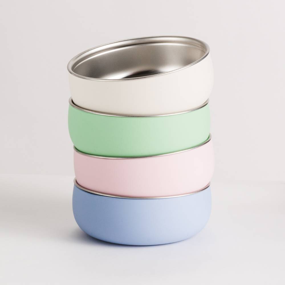 A stack of 4 Nestling Stainless Steel Large Bowls - from top to bottom - Oat, Sage, Dusty Pink and Dusty Blue.