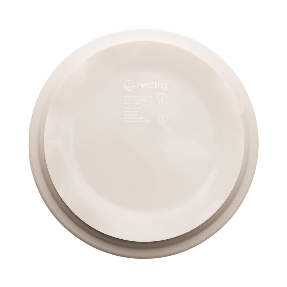 A clearcut image of the Nestling Stainless Steel 20cm Divided Suction Plate in the colour Oat. This is showing the back/underside of the plate showcasing the suction feature.