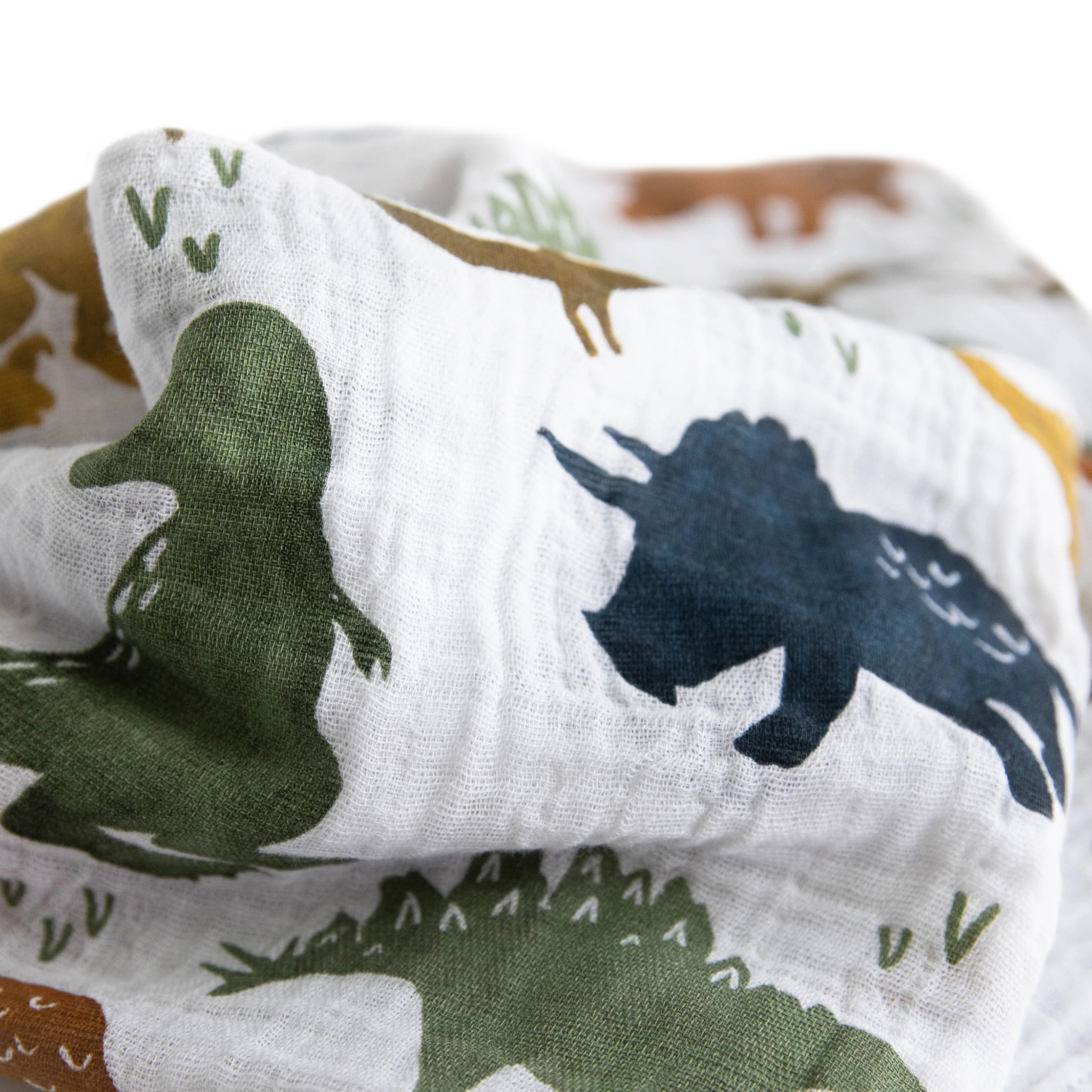 Close up of Little Unicorn single cotton muslin swaddle wrap in Dino Friends print