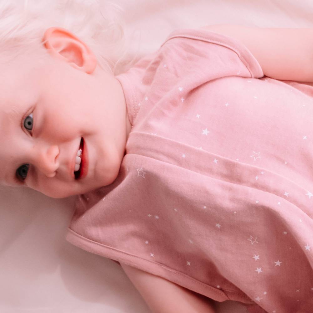 Toddler girl wearing woolbabe merino/organic cotton sleeping bag in dusk stars