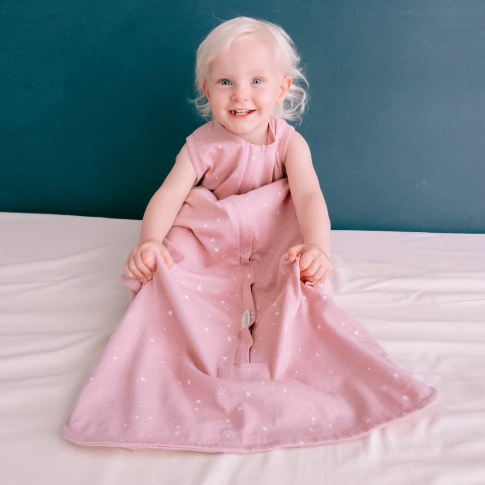 Toddler girl wearing woolbabe merino/organic cotton sleeping bag in dusk stars