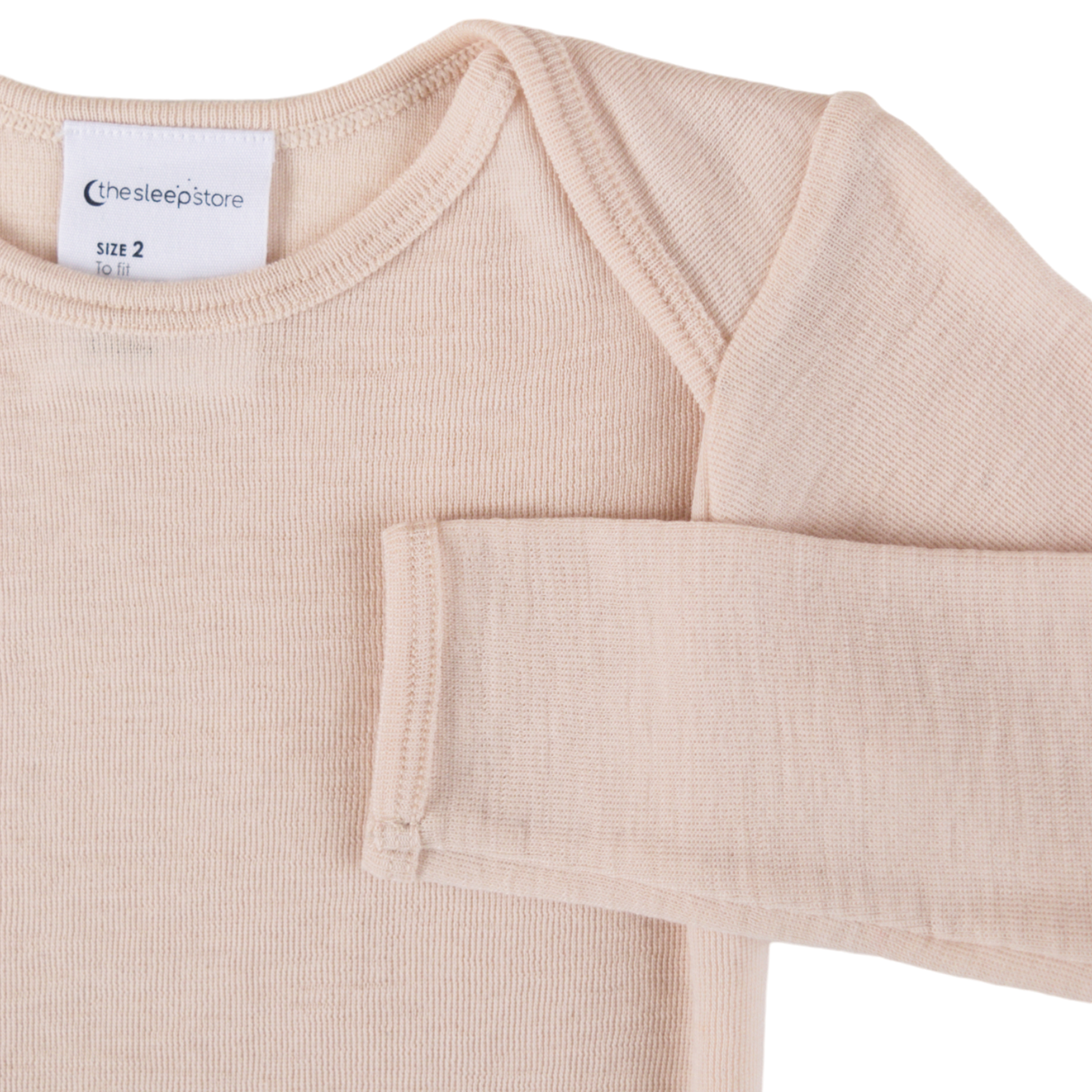 Close up showing envelope neck and arm on The Sleep Store Deluxe Merino Rib Long Sleeve Bodysuit