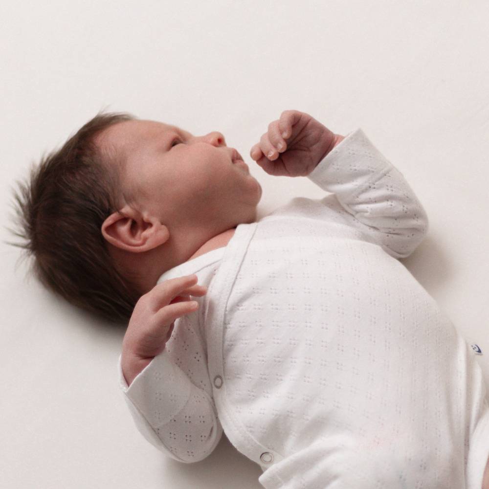 The Sleep Store Organic Cotton Pointelle Kimono Long Sleeve Bodysuit is a cool layer for summer babies