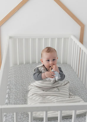 newborn sleeping in cot